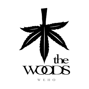 Stylized black six-point leaf with a central vertical spike above the words 'the WOODS' with interlocking O's.